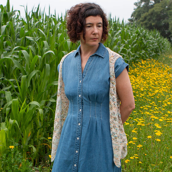 Knitted sweater with knitting needles and flowers on a textured surface, featuring 'Seasons Club Summer 2025 Digital Club' text.